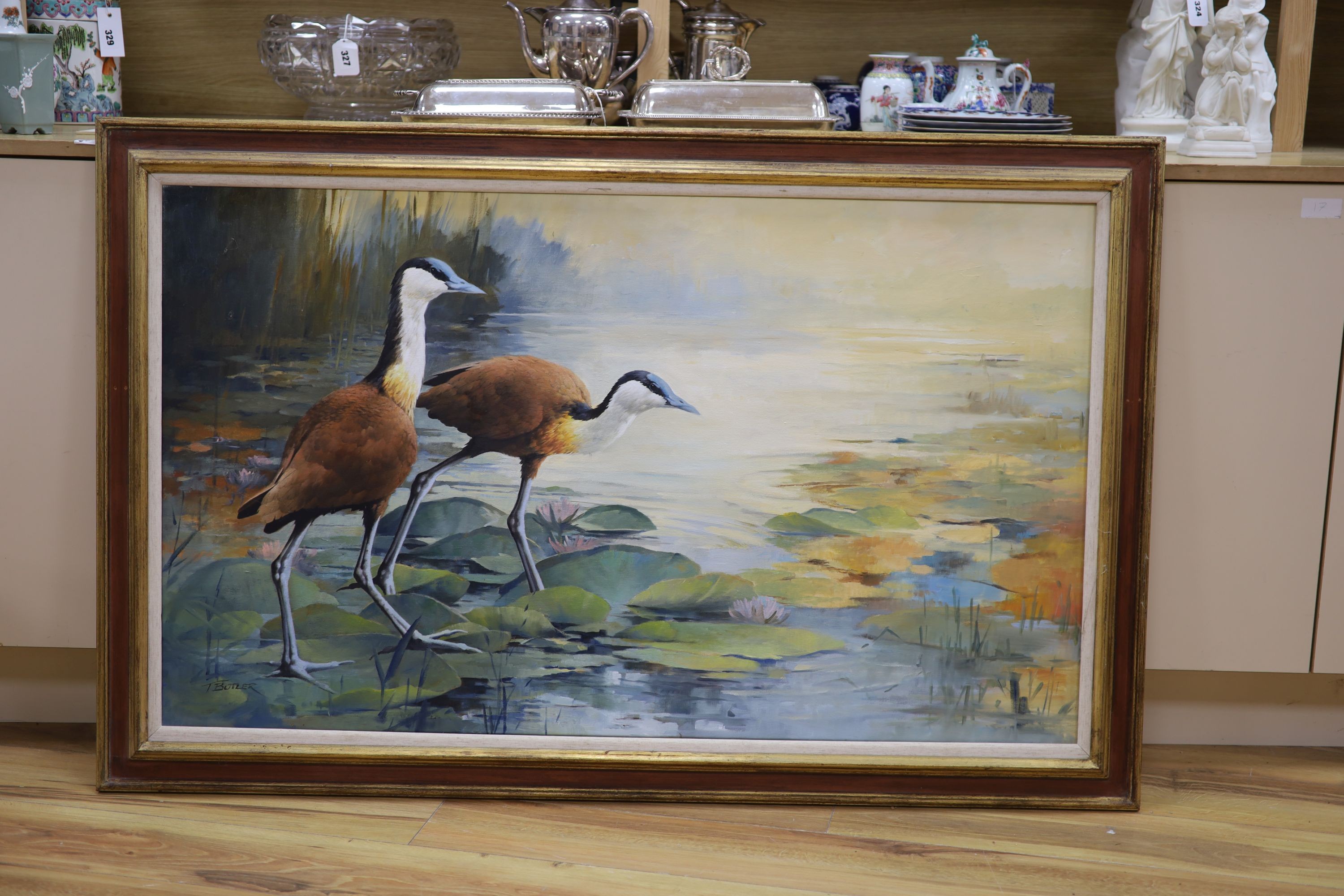 Tony Butler (1945-), oil on canvas, Wading birds on lily pads, signed, 70 x 118cm